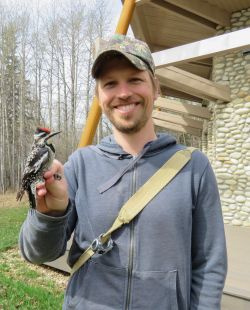 Image of Brian Weeks holding a bird in his right hand.