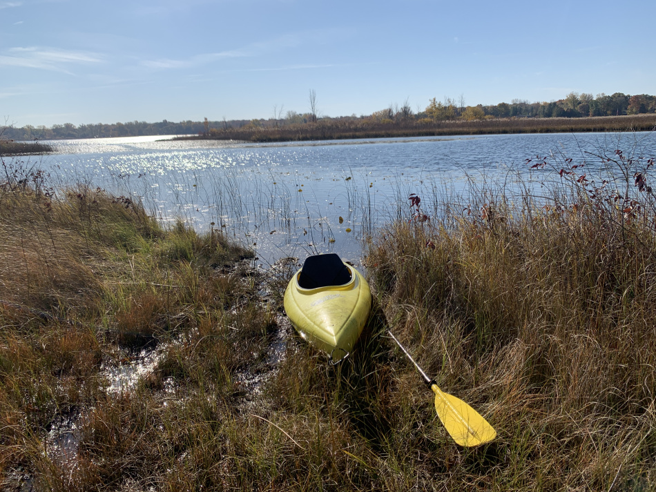 Photo of a kayak docked at the entrance to the prairie fen at the north side of Bass Lake