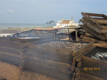 Stacked trays of fish being smoked outdoors in the coastal Ghanaian  city of Elmina. Photo by Pam Jagger, University of Michigan.