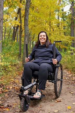 Kiley Adams shows off the trailchair. Photo by UMSocial