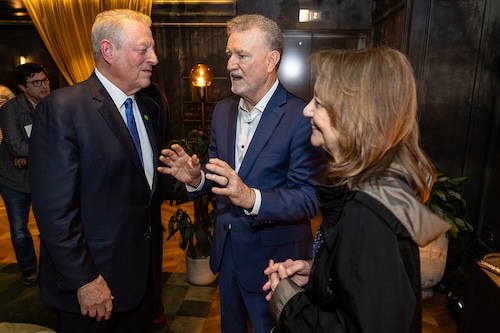A photo of Bierbaum in conversation with Gore and another guest.
