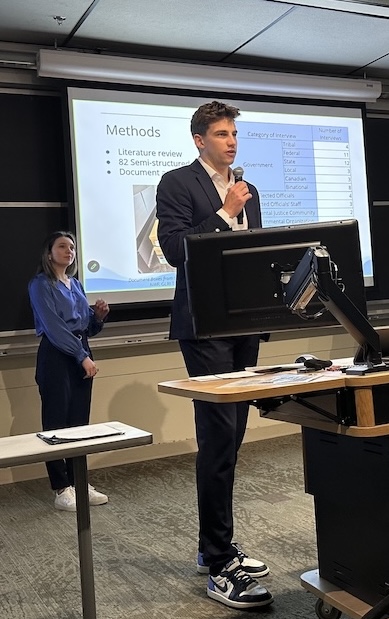 Will Tschetter (BS ’24, MS ’26) stands at a podium presenting at the annual SEAS Capstone Conference.
