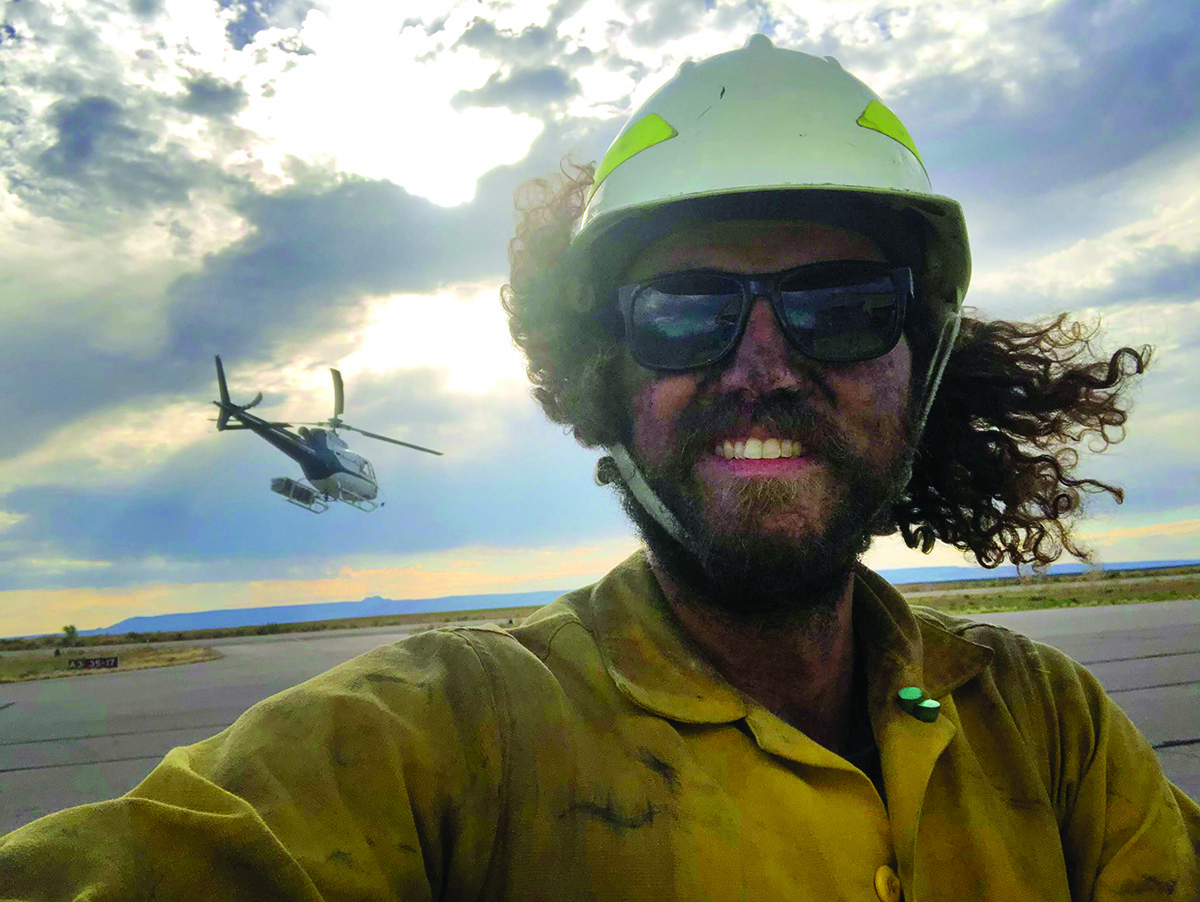 Harold Rice stands near the Moab helitack crew’s helicopter following a fire operation near Blanding, Utah.