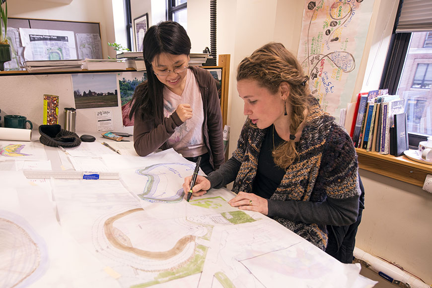 Two master of landscape architecture students work in the studio space.