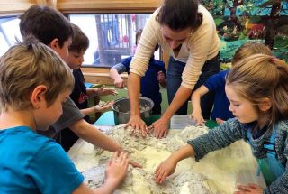 Slutzker teaches kids how to make a papier mache model of their local watershed. during her time as an AmeriCorps member in Montana