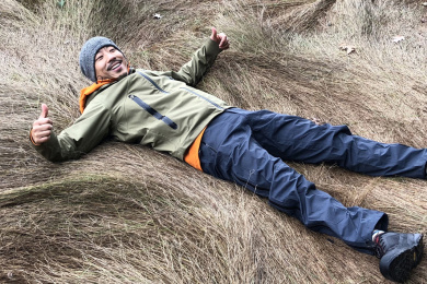 Tao Zhang laying in a field