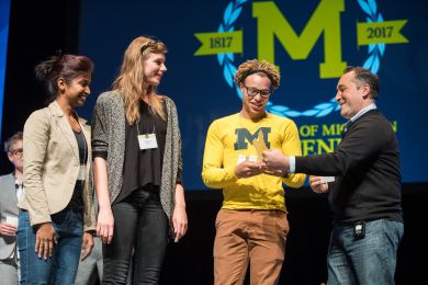 From left, Shruti Soni, Shannon Sylte and Derell Griffin receive their award from &amp;quot;Campus of the Future&amp;quot; judge Babak Parviz after being named the competition&amp;#039;s winner. (Photo by Austin Thomason, Michigan Photography)