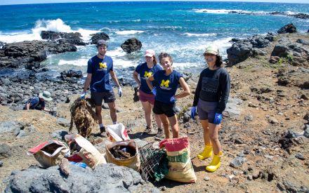 SEAS master&#039;s students working with community members to clean up the coastline of Mo‘omomi Beach in Moloka‘i.