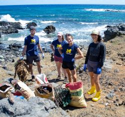 SEAS master&#039;s students working with community members to clean up the coastline of Mo‘omomi Beach in Moloka‘i.