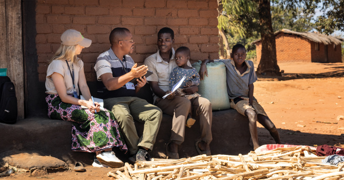 SEAS master&#039;s student Andrea Mahieu and Lilongwe University of Agriculture and Natural Resources researcher Alfred Magombo interview study participants in Kazizila Village, Malawi, about the ownership, use and impacts of solar technologies.